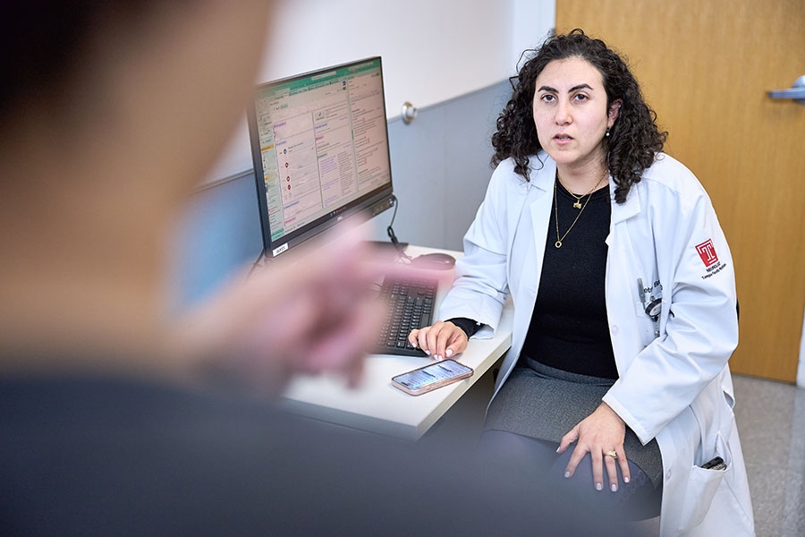 Dr. Petra Brayo sitting at her computer desk