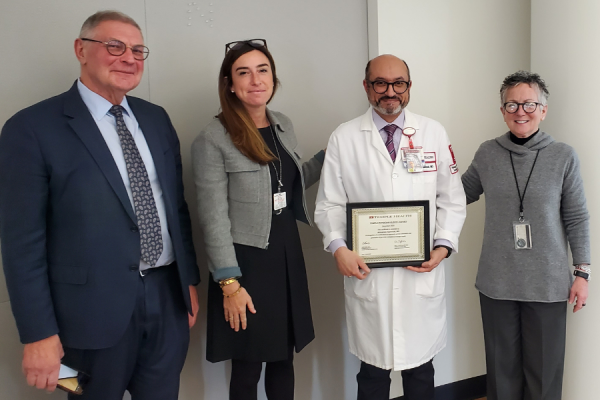 Dr. Alsammak (center right) receives his TFP Kudos Award from Claire Raab, MD, President & CEO of Temple Faculty Physicians (center left); Amy J. Goldberg, MD, FACS, The Marjorie Joy Katz Dean of the Lewis Katz School of Medicine (far right); and Dr. Yuri Persidsky (far left).