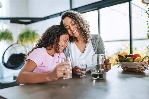 Cheerful parent and child enjoying water with each other.
