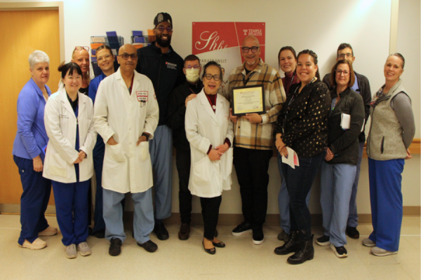 Charles (center right) and some of his colleagues celebrate his Manager of the Quarter award.