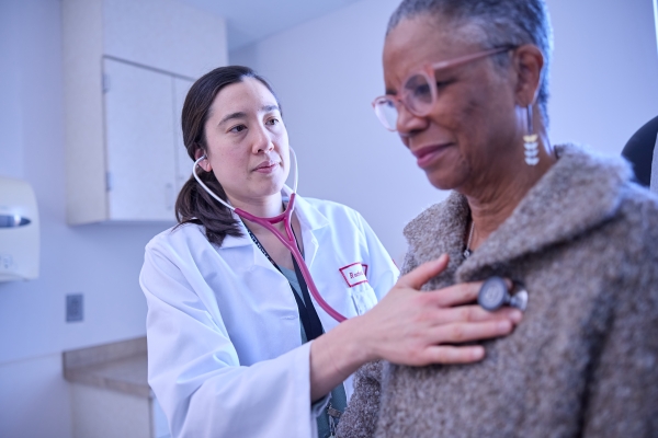 Provider listening to a patient's lungs