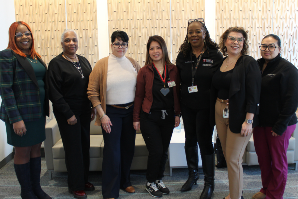 Yannarong Sen (center) celebrates her TFP C.A.R.E.S. Award with her coworkers.