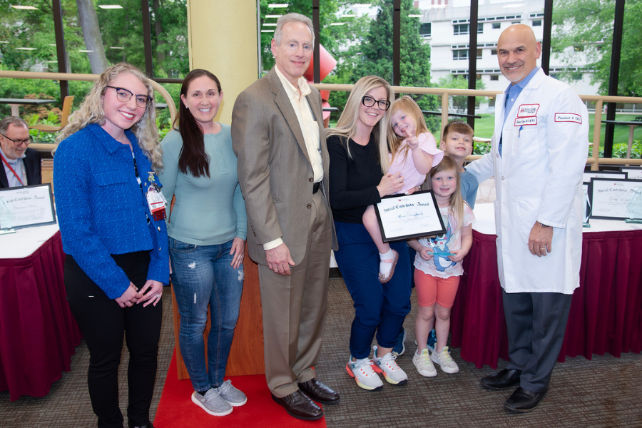 Alicia Dougherty, Nursing Professional Development Specialist, Nursing Education and Quality Assurance, Fox Chase (fifth from right) with her children and (from left) presenting speakers Nicole Bespalov and Amber Bender; Jonathan Chernoff, MD, PhD, Cancer Center Director; and Fox Chase President and CEO Robert Uzzo, MD, MBA, FACS.