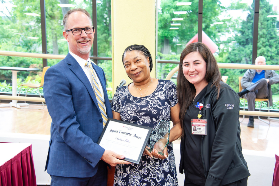 Robin Fisher, Environment Assistant II, Environmental Services, TUH – Jeanes Campus (center) with (from left) TUH – Jeanes Campus Executive Director Matthew Shelak, OTR/L, MBA, and presenting speaker Anna Kirk.