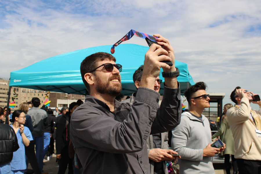 Man taking picture of eclipse