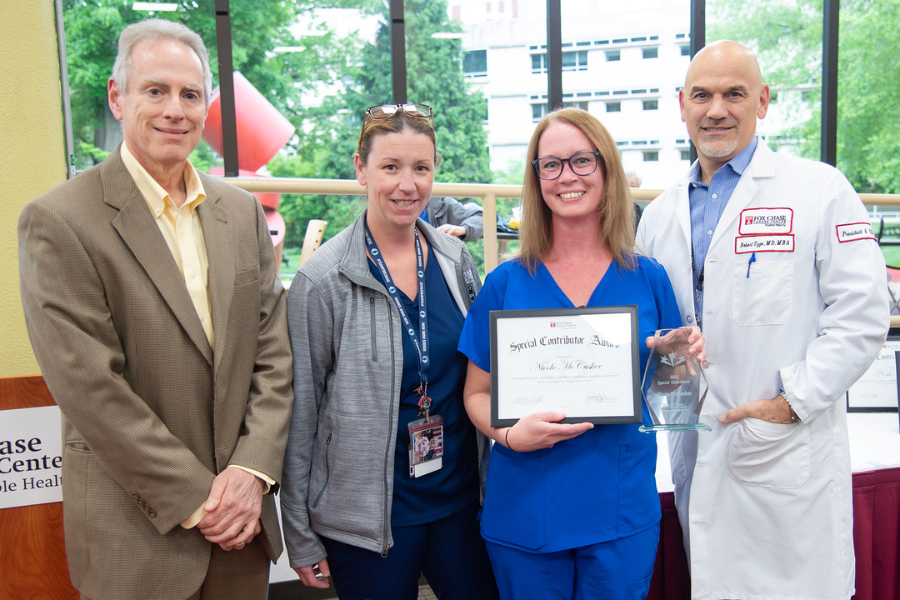 Nicole McCusker, Secretary II, Outpatient Infusion, Fox Chase (second from right) with (from left) Jonathan Chernoff, MD, PhD, Cancer Center Director; presenting speaker Colleen Reinheimer; and Fox Chase President and CEO Robert Uzzo, MD, MBA, FACS.