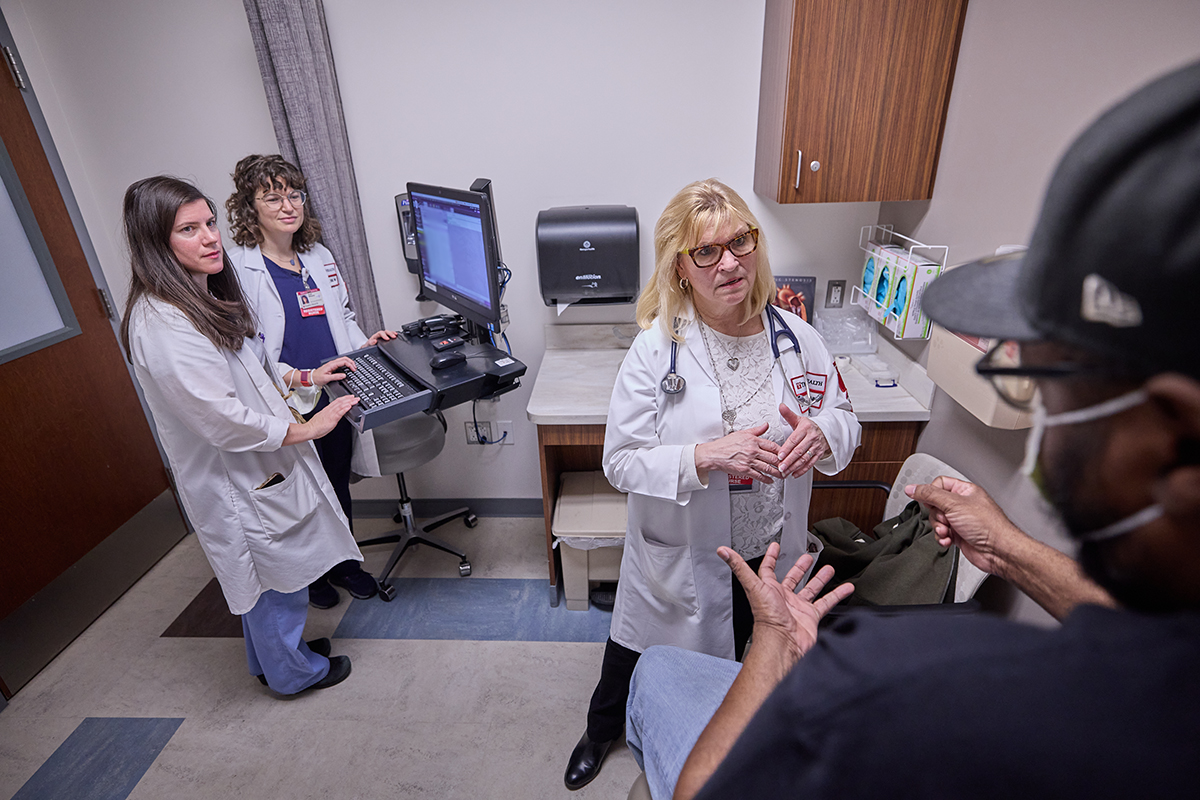 staff with patient at computer