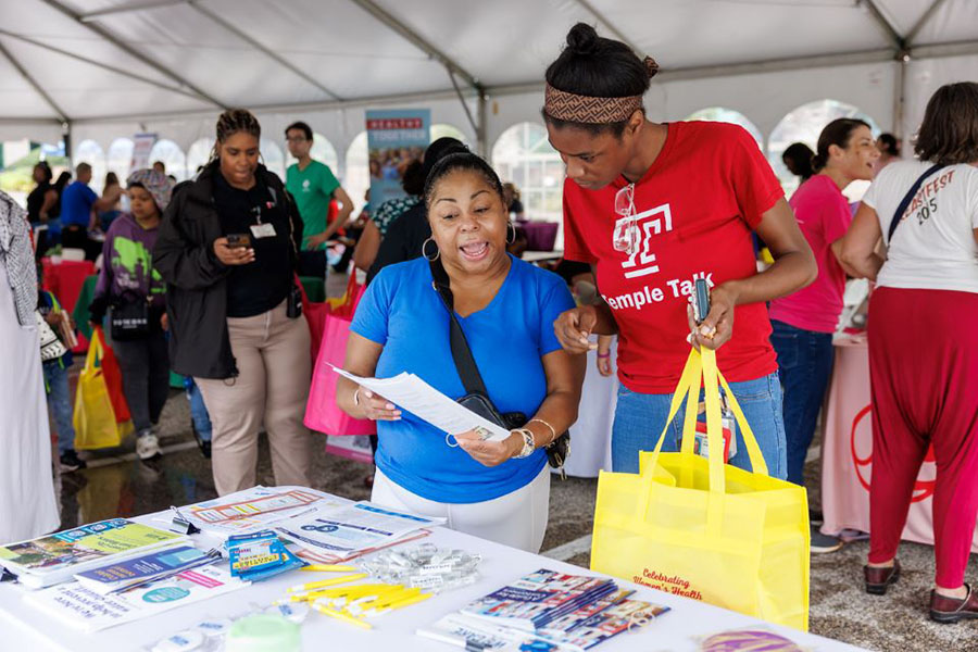 Talking through educational materials about the Temple Women & Families Campus.