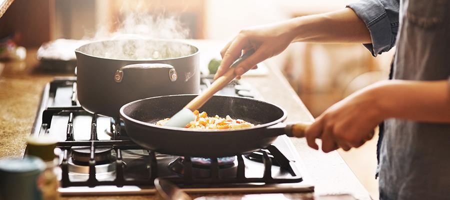 Woman cooking healthy recipe on stove