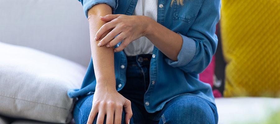 Woman itching her arm