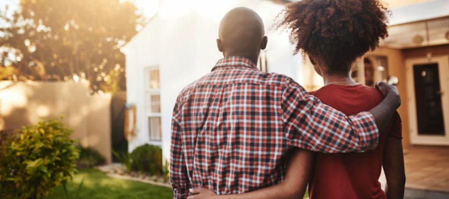Young couple looking out at their house