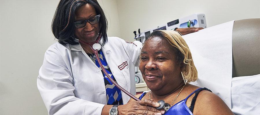 Dr. Crabbe checking woman's heart