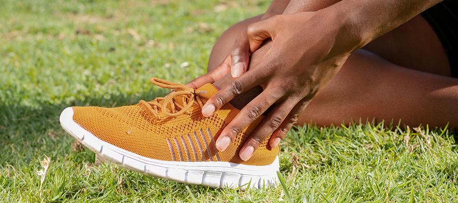 Woman holding ankle in pain