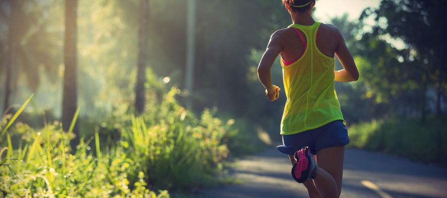 Female running down winding road