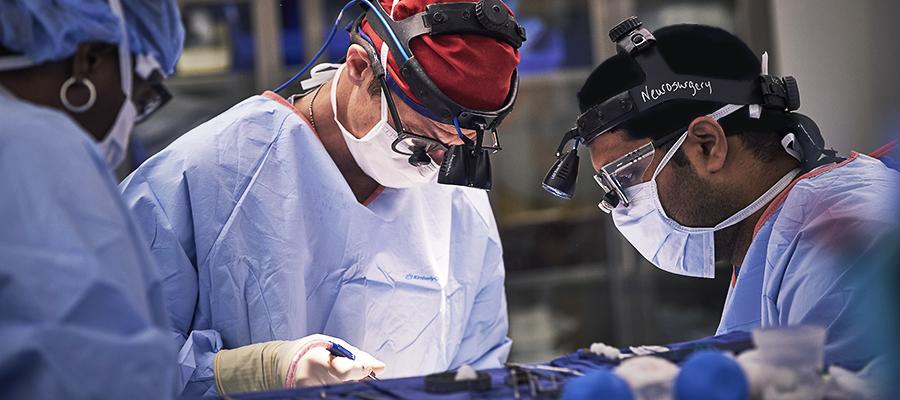 Three neurosurgeons in operating room 