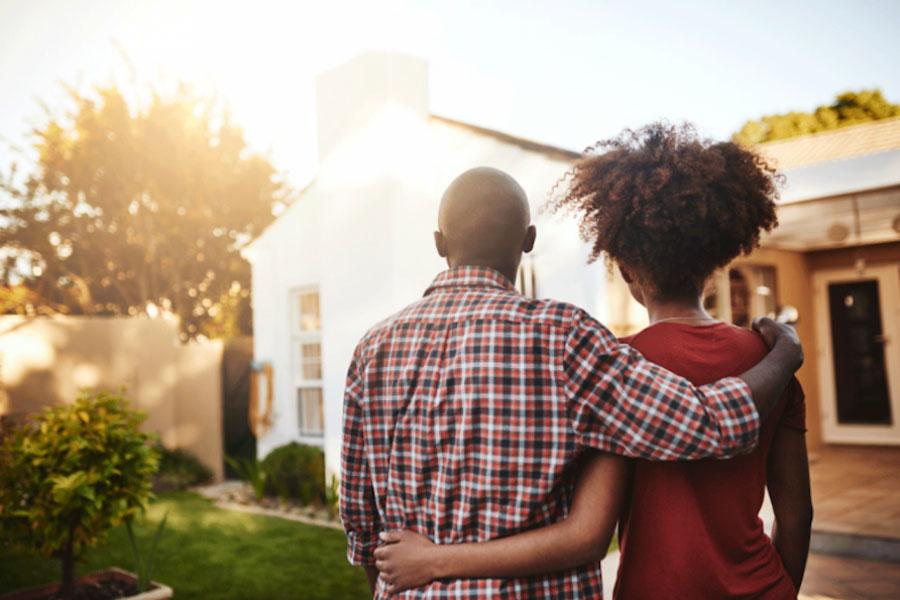 Young couple looking out at their house