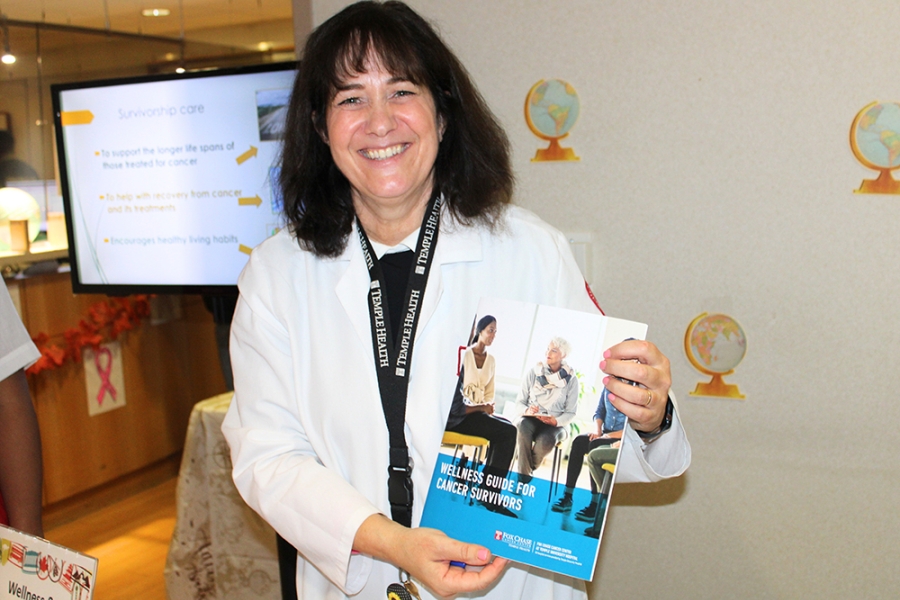Woman holds up literature.