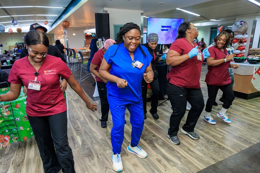 Team members show off their dance moves at TUH-Main.