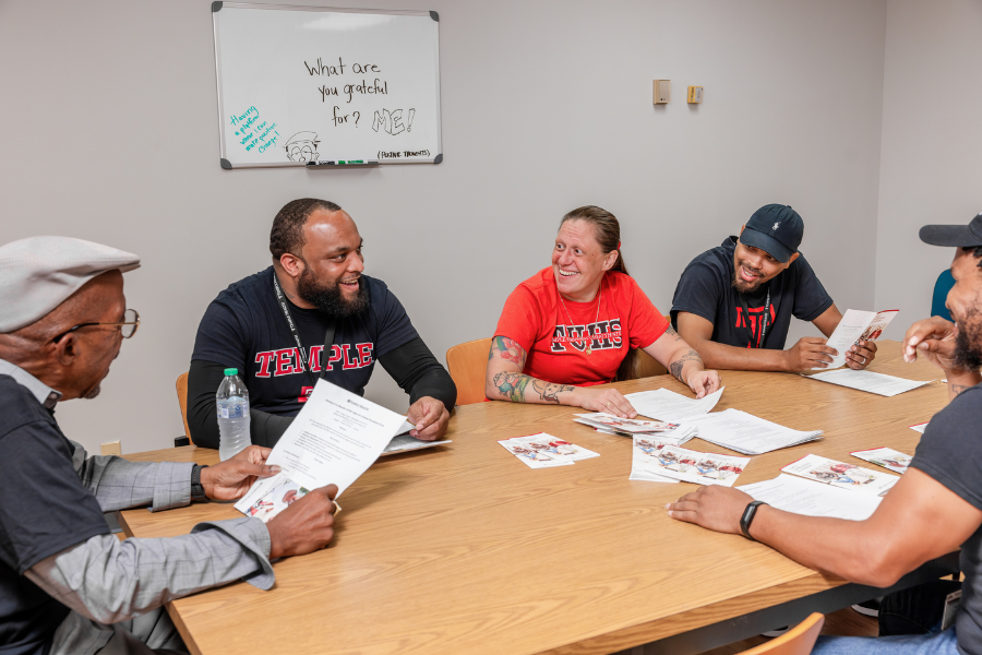 The team shares a laugh while Robertson discusses a successful patient interaction.
