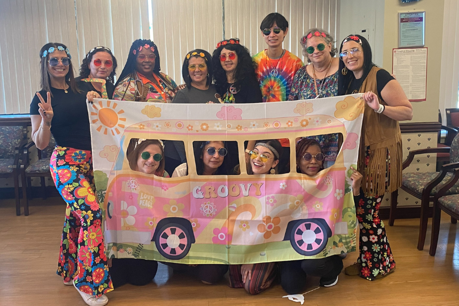 Our Temple Physicians at Rockledge team poses with a very groovy 'van' for their "It's Hip to Be Healthy" event.