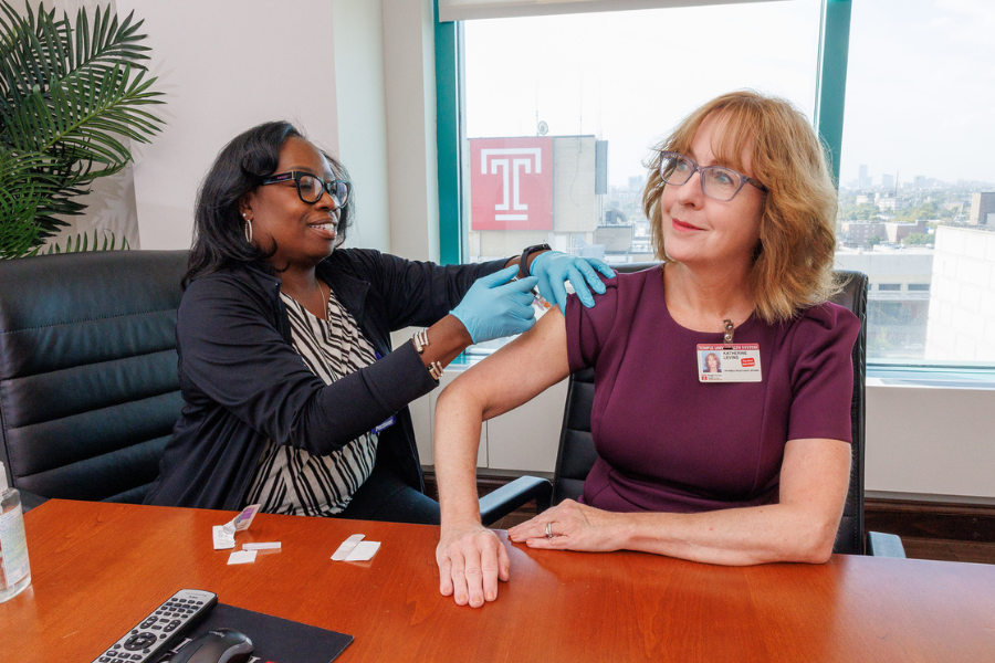 Katherine E. Levins, JD, MBA, Vice President of Public Police and Government Affairs, receives her flu vaccination.
