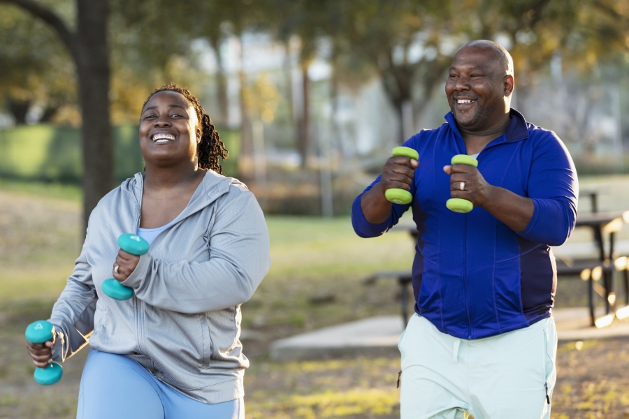 Couple exercising in park with hand weights