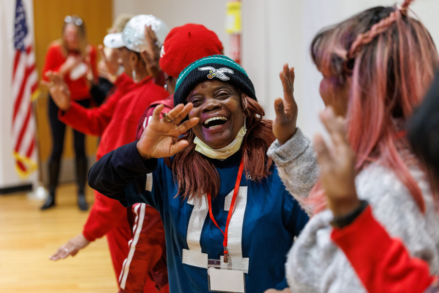Waving to the camera mid-Laughter Yoga!