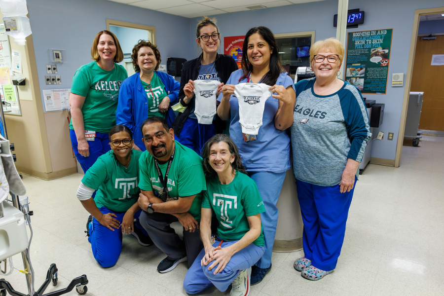 Some of our NICU team members with the Eagles onesies for our newborns.