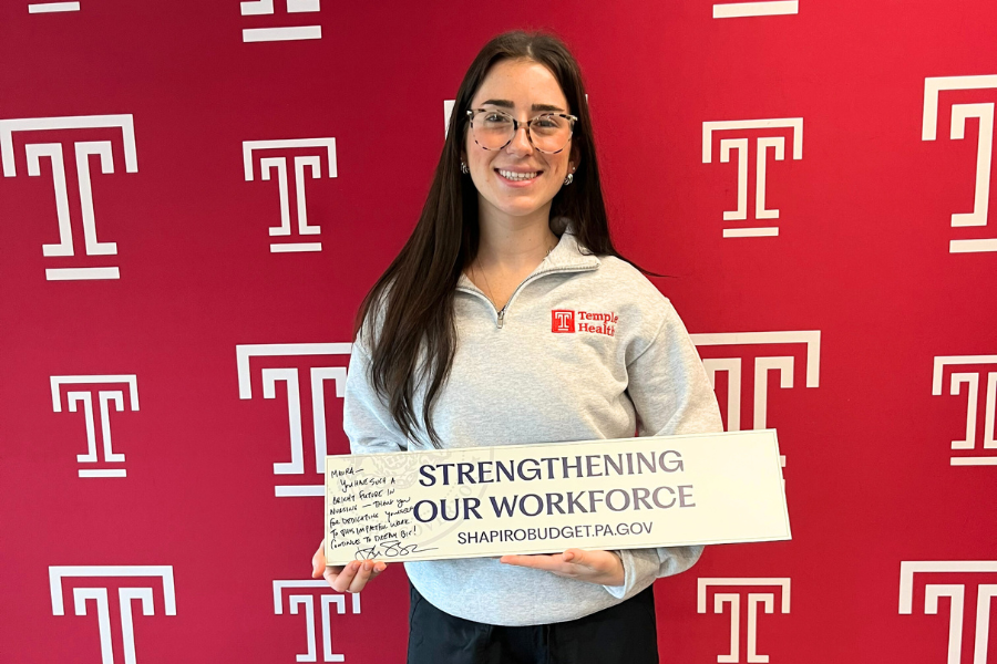 Maura with the podium sign from the press conference, signed with a personal message from Governor Shapiro.