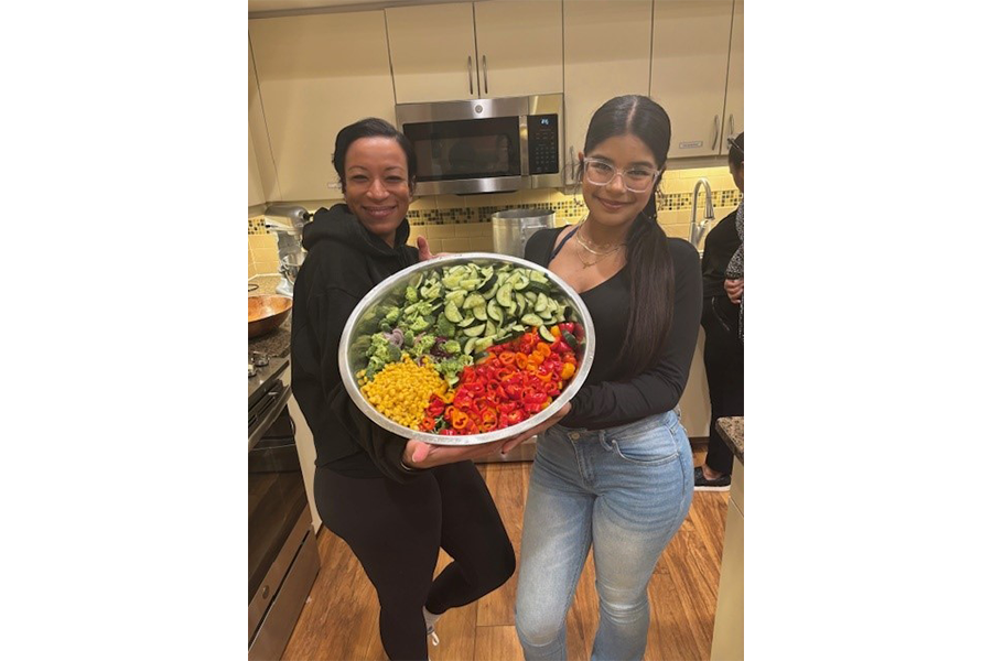 Indira Kwaadu (left) and Krystal Cartagena’s daughter Jamie (right) show off a colorful salad.