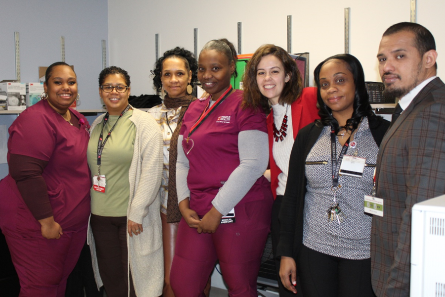 Shaquanna Jordan (center) celebrates her TFP C.A.R.E.S Award with her colleagues.