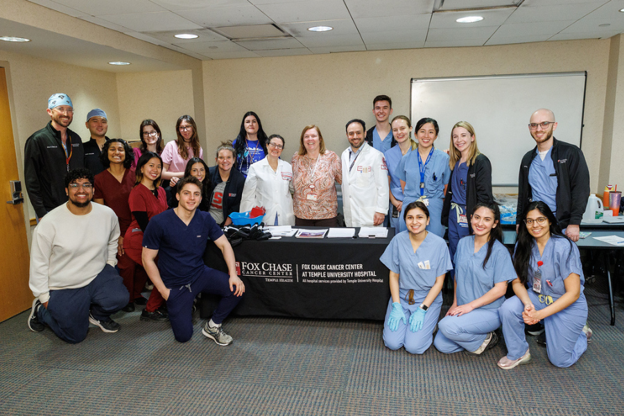Temir Duisenbek and Karan Patel with the poster for their project, "Geographic Compliance and Placement.