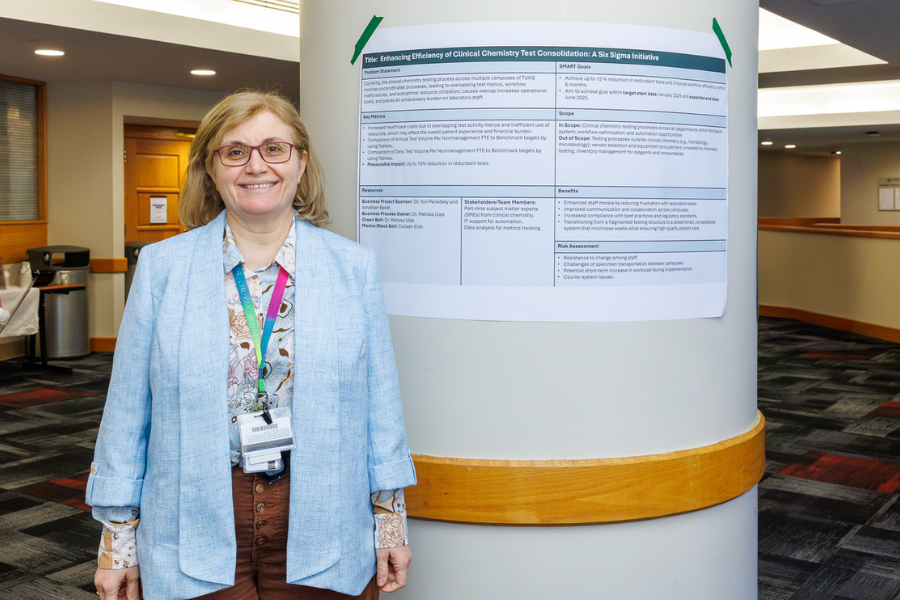 Melissa Ulas with the poster for her project, "Enhancing Efficiency of Clinical Chemistry Test Consolidation.