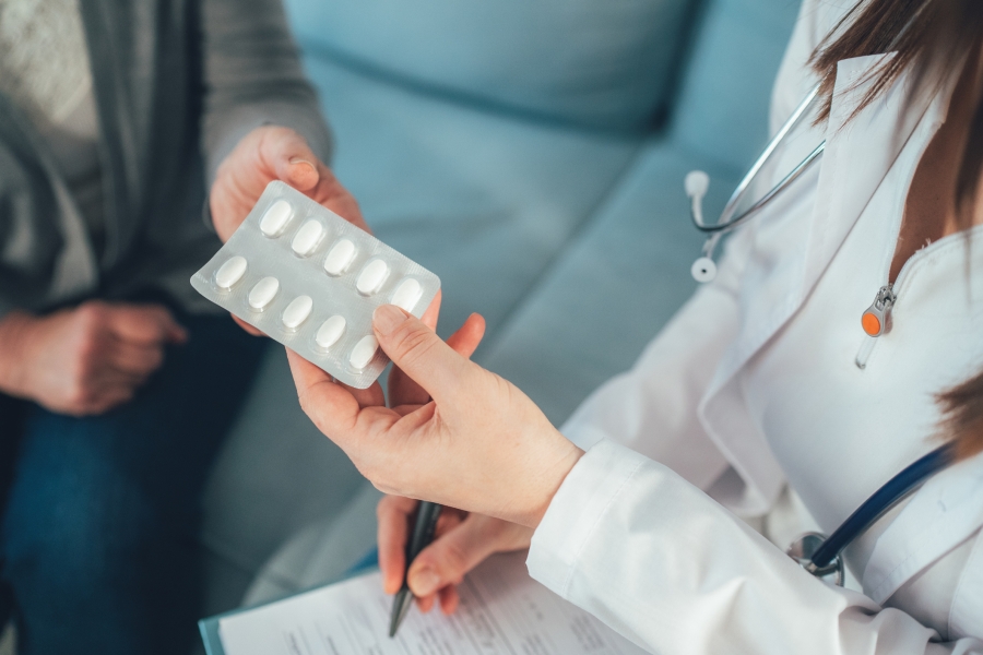 Doctor handing patient medication