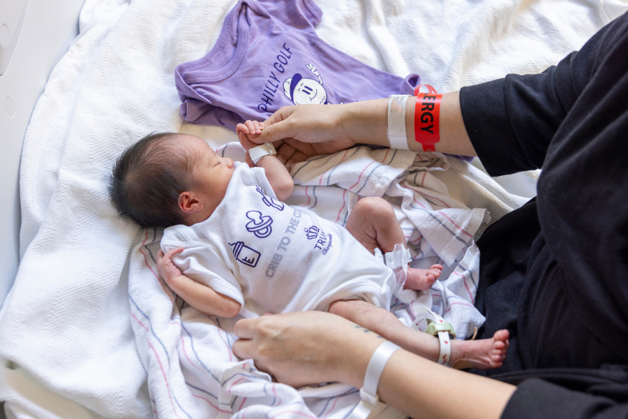 One of the babies born during tournament week, wearing a gifted Truist Championship onesie.  