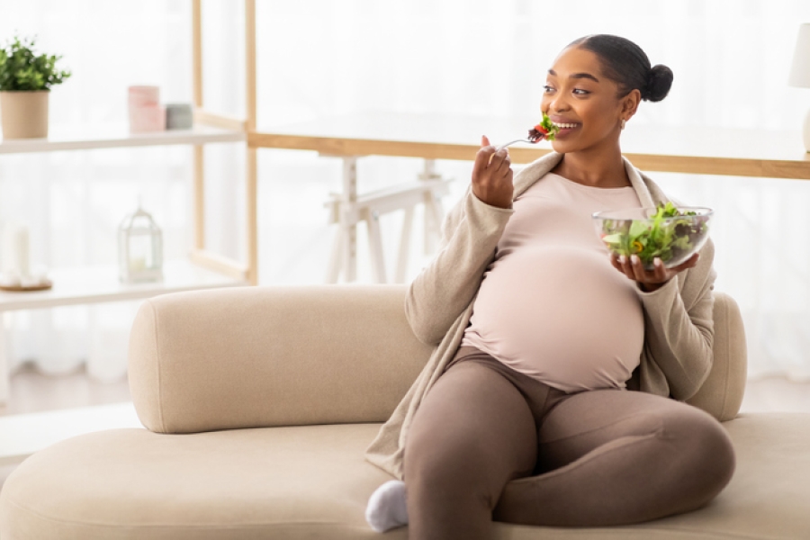 Pregnant woman enjoying salad