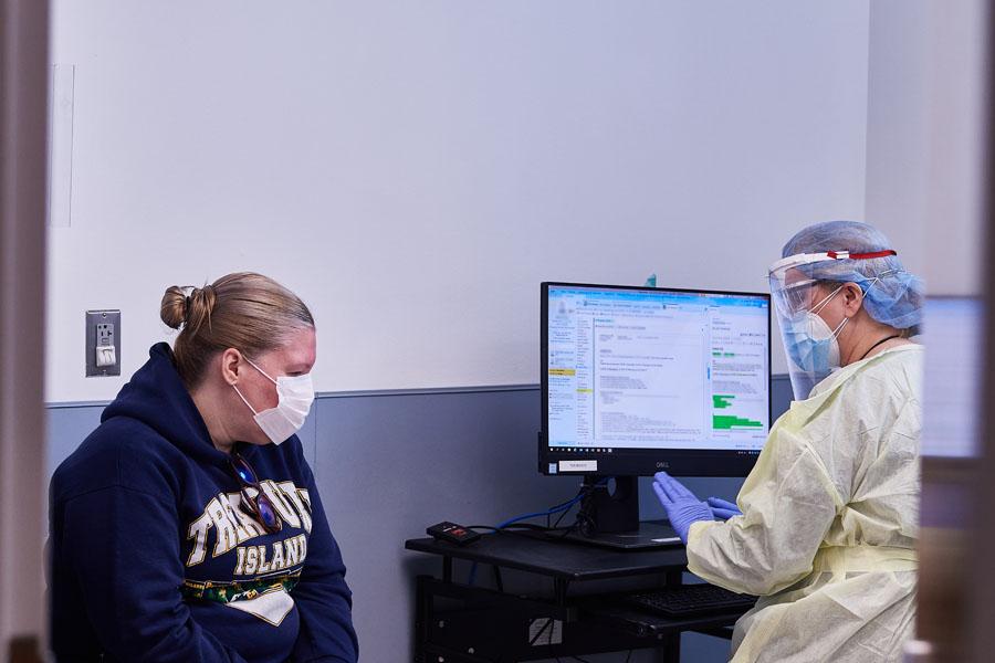Doctor and patient wearing masks for consultation