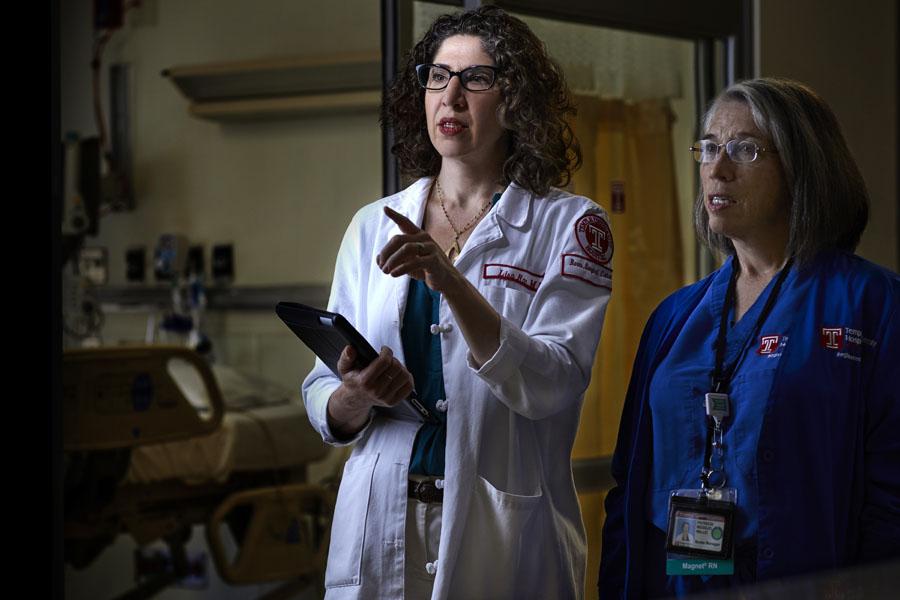 Lisa Rae, MD, FACS talking with another physician at the burn center