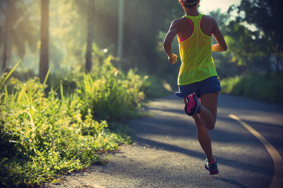 Female running down winding road