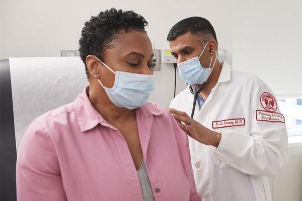 Dr. Kartik Shenoy examining a patient