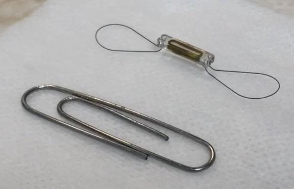 CardioMEMS Heart Failure device compared in size to a paperclip
