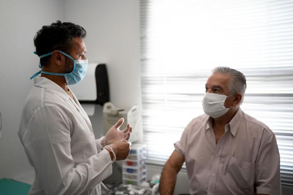 Patient in medical consult wearing a face mask
