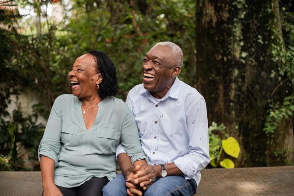 Senior couple holding hands and laughing outside