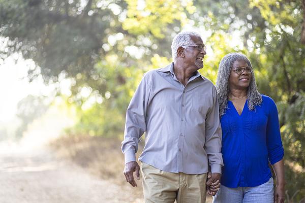 Older couple walking and holding hands