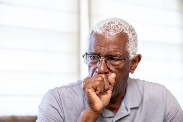Man coughing into his hand