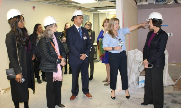 Kim Hanson (center right) gives the delegation a tour of the construction at Temple Women & Families Campus.