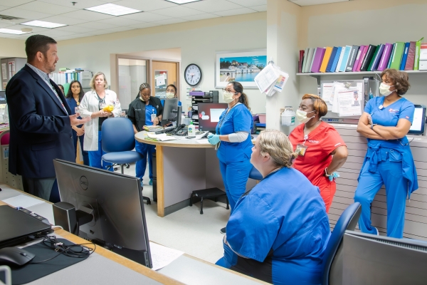 James Hazlett, MSN, RN, NE-BC, VP, and CNO of TUH-Jeanes Campus, presents the DAISY Award to Rachel Thomas.