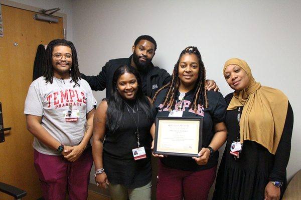 McQueen's colleagues help her celebrate her achievement.