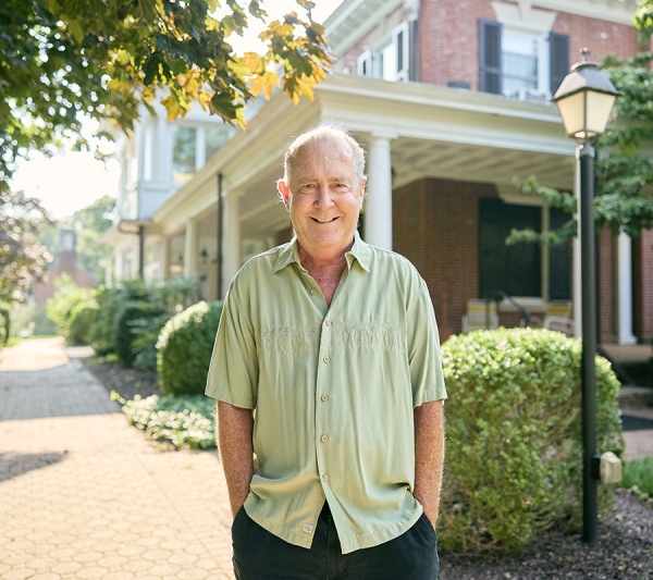 Ted F. standing in front of house