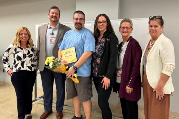 Patrick (center left) celebrates his BEE Award with his colleagues.